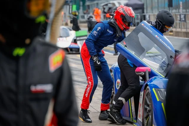 Andrei climbing out of the Ligier JS P4 at a driver change