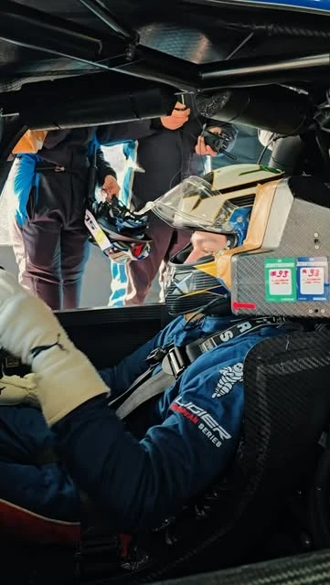 Andrei strapped into the Ligier cockpit